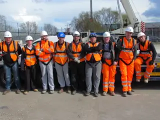 Operatives wearing orange hi-vis and height safety gear